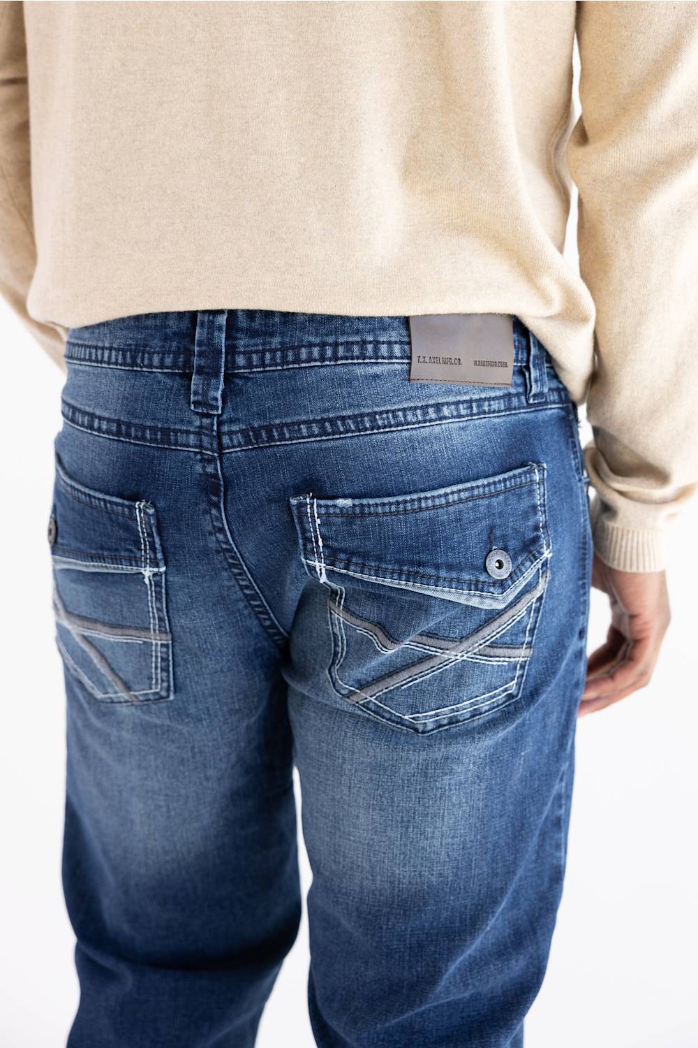 A person wearing Axel Jeans Theo vapor wash straight-leg denim jeans, showing the back pockets with decorative stitching and flap detailing.