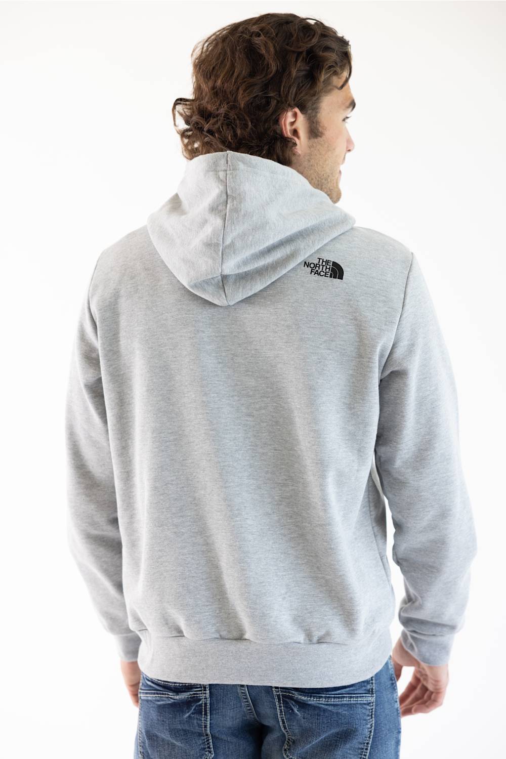 A man wearing a light gray heather hoodie from The North Face, shown from the back and side against a plain white background.