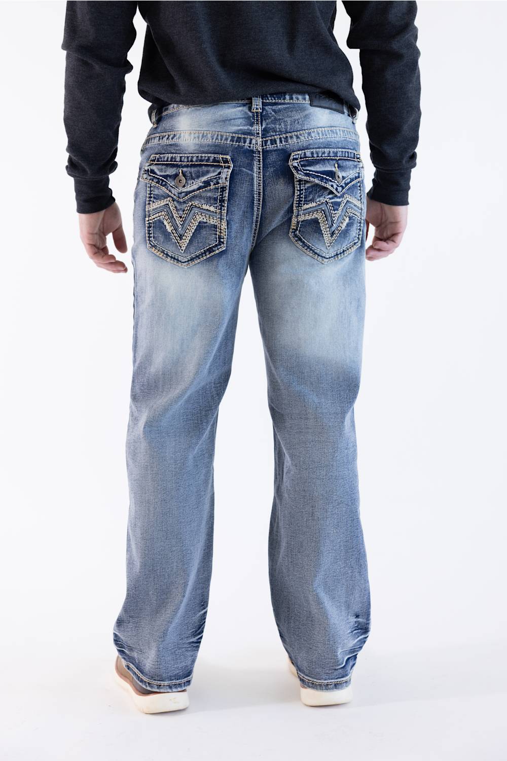 Rear view of a model wearing True Luck Weller loose straight jeans with back pocket embroidery, paired with a dark long-sleeve shirt.