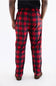 Red and black buffalo plaid pajama pants with a repeating deer  pattern, shown on a model from the back against a white studio background.
