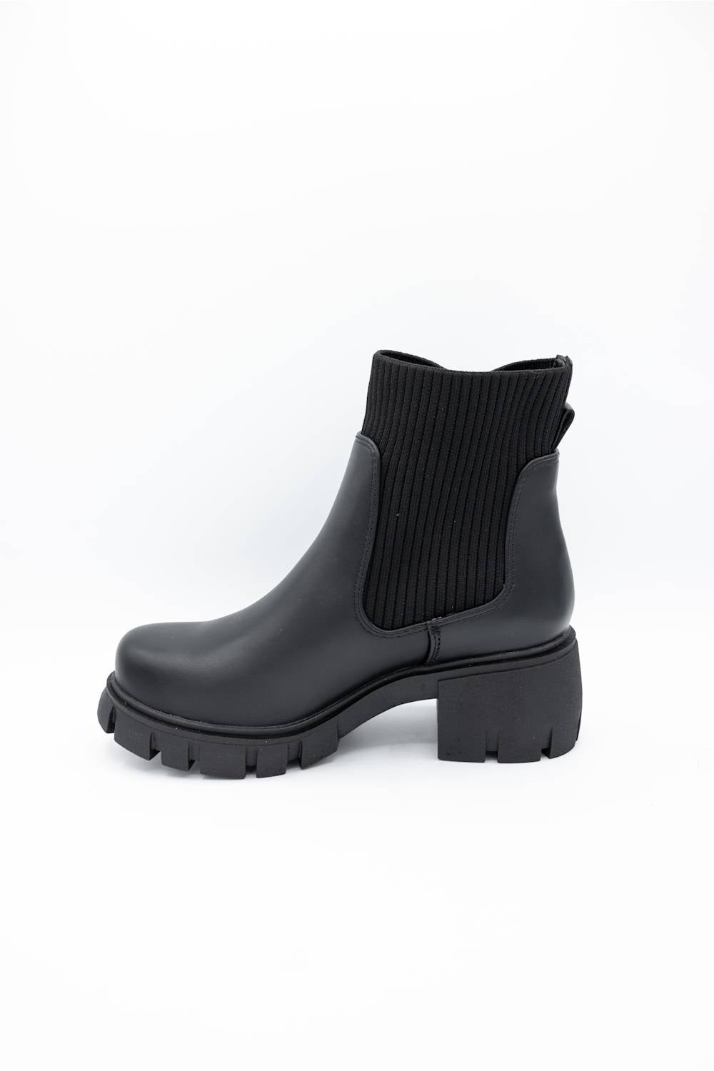 A single black ankle boot with a ribbed elastic side panel and a chunky lug sole, photographed on a clean white background.