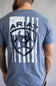 Back of a slate blue t-shirt featuring a distressed white American flag logo with the Ariat brand name.