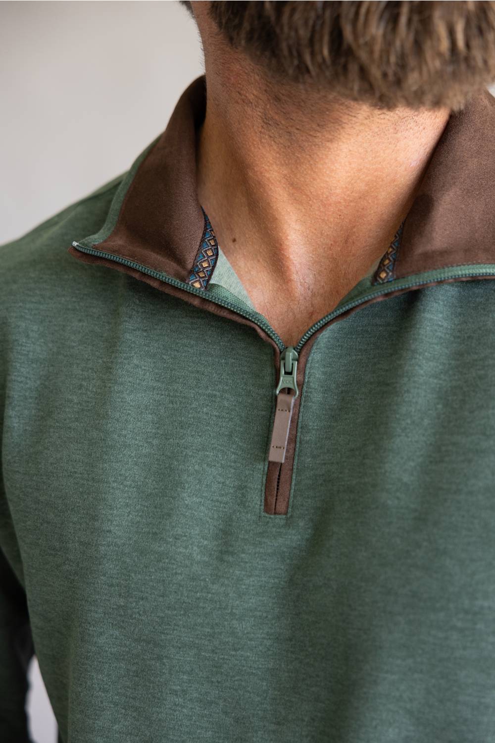 Buttery soft, zipneck pullover with brown zipper and collar accents 