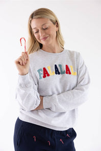 1897 Active Falalala Patch Embroidered Fleece Sweatshirt for Women in Ice Grey in ice grey fleece, featuring colorful chenille patchwork lettering that reads "Falalala" across the chest, styled with a candy cane held near the collar.