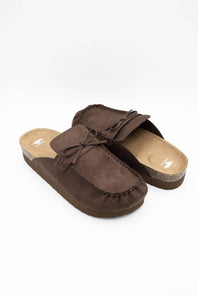 A pair of dark brown suede mule slippers with bow details, displayed on a clean white background.