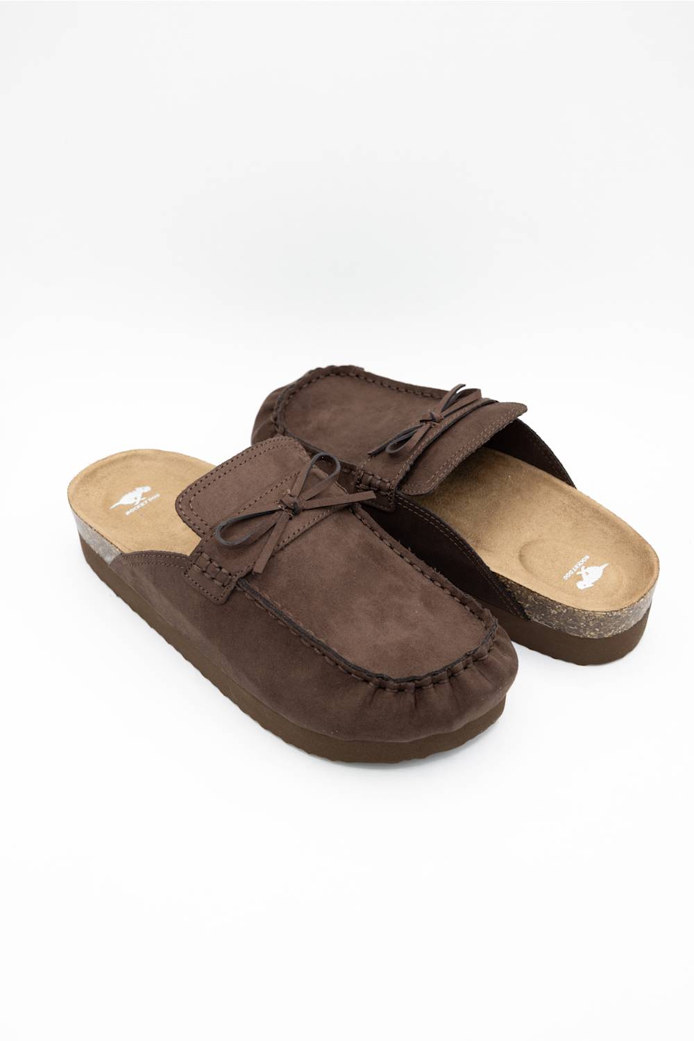 A pair of dark brown suede mule slippers with bow details, displayed on a clean white background.