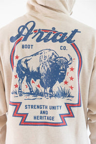 Close-up of the back of a beige hoodie featuring a large blue and red graphic print of a bison with the text 'Ariat BOOT CO.' and 'STRENGTH UNITY AND HERITAGE'.