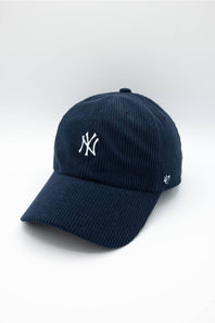 A navy blue corduroy baseball cap featuring a white embroidered New York Yankees logo on the front and a white '47' brand logo on the side, set against a clean white background.