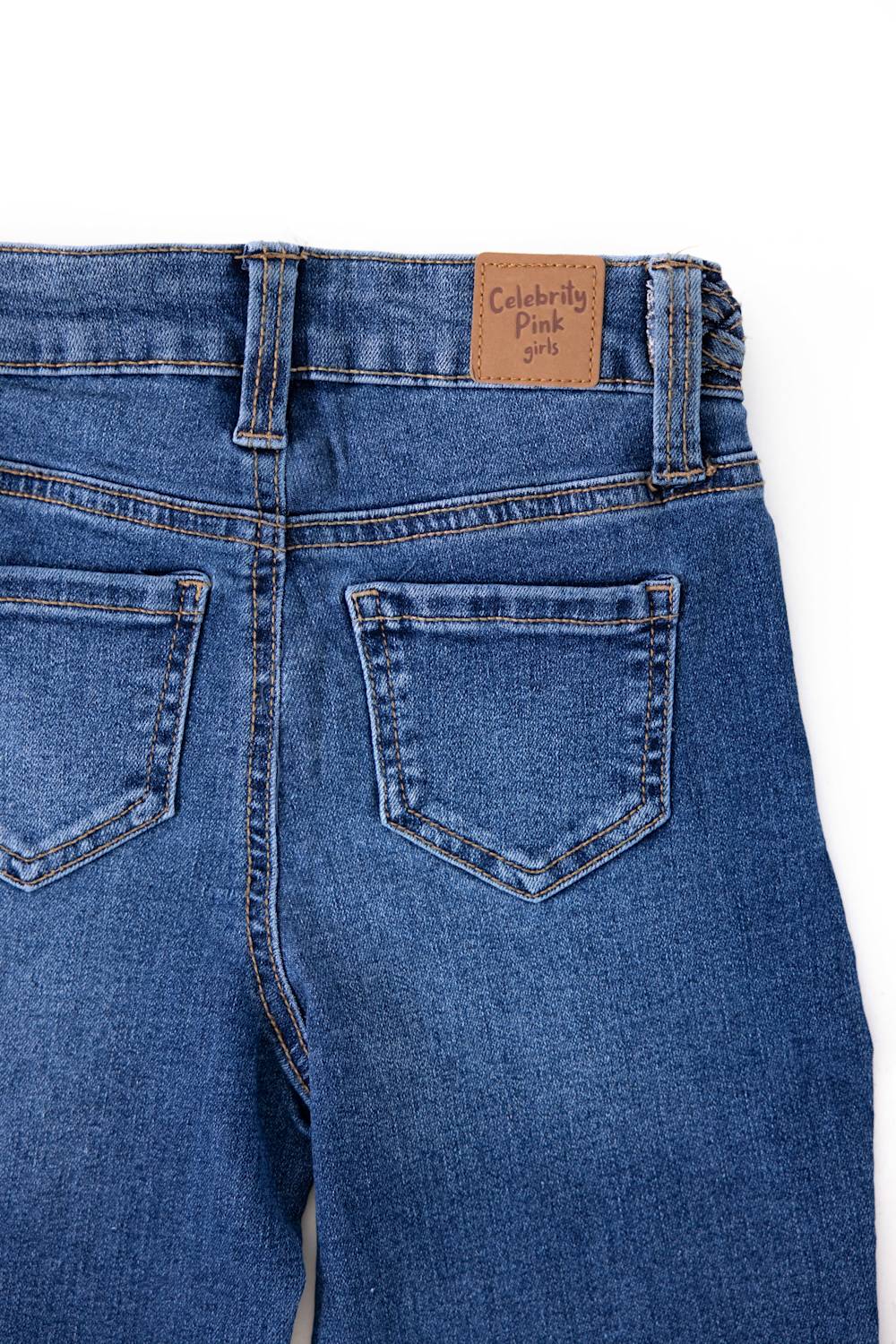 Close-up view of the back pockets and waist on Celebrity Pink Girls Braided Waistband Flare Jeans in Nancy medium wash