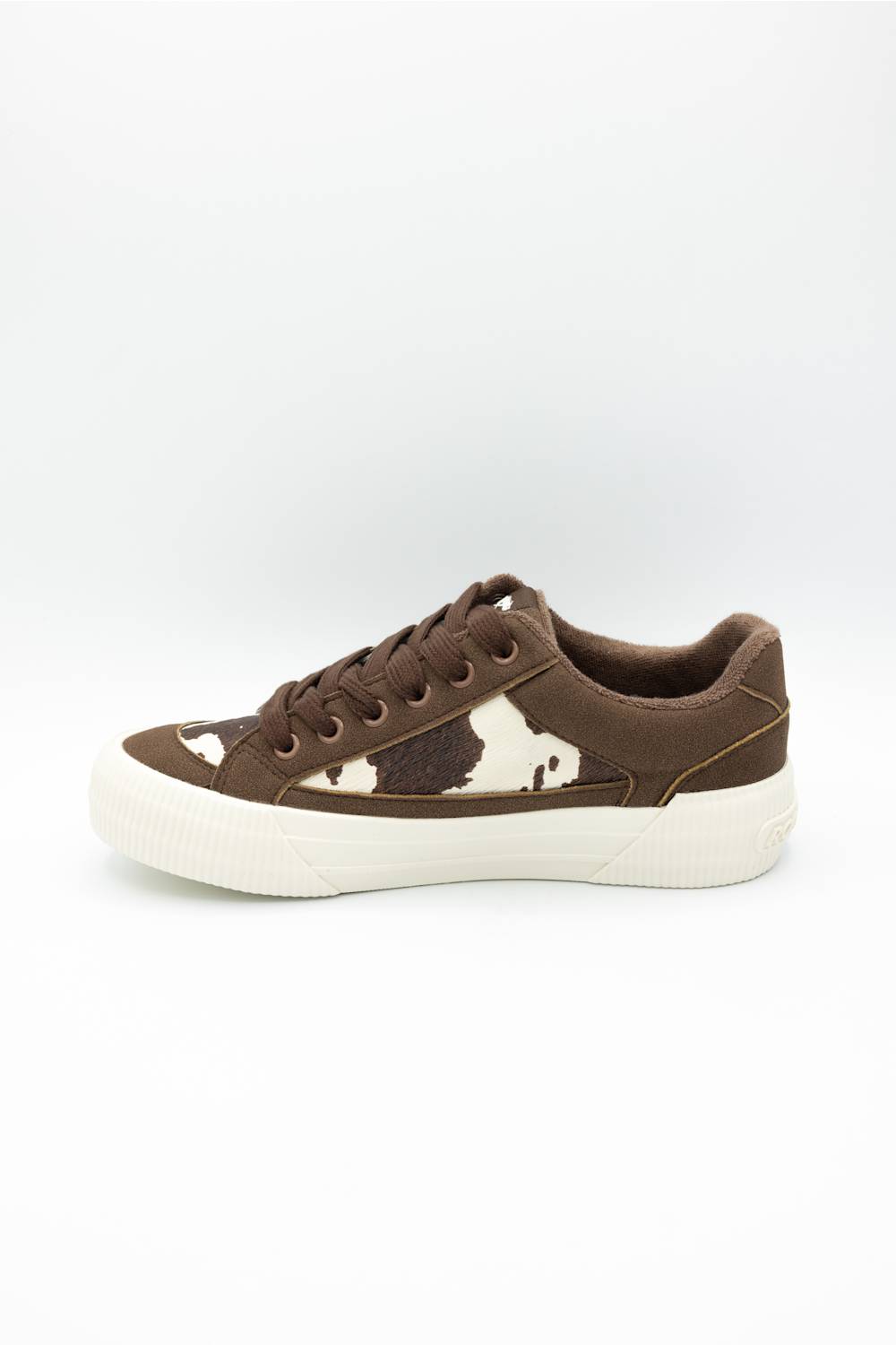 A low-top sneaker in brown suede and cowhide with a thick white rubber sole, shown from a side profile on a white background.