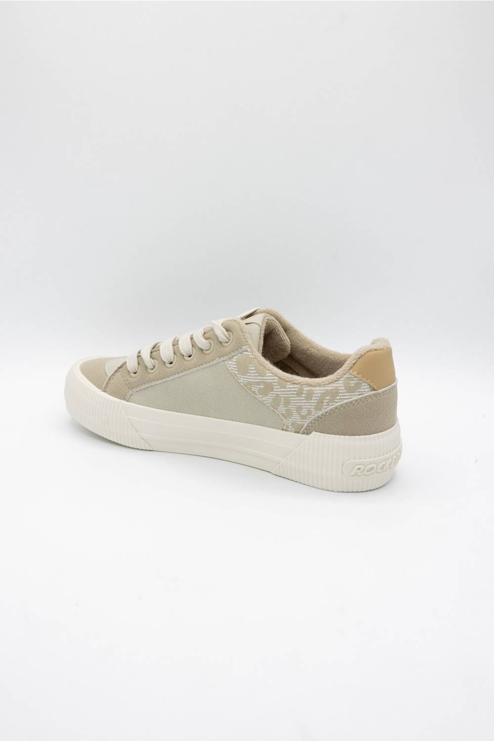 A low-top sneaker in beige and off-white, featuring a textured patterned side panel, beige laces, and a thick white rubber sole, shown from a side-rear angle on a white studio background.