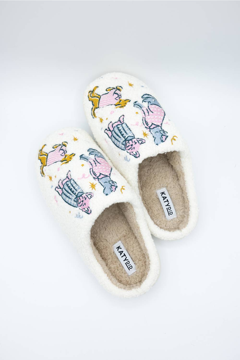 birds eye view of dog wearing pajamas design on comfortable sherpa house slippers