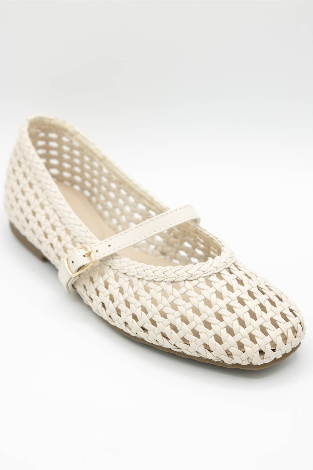 A single cream-colored woven mesh Mary Jane flat shoe with a small gold buckle, shown on a light gray studio background.