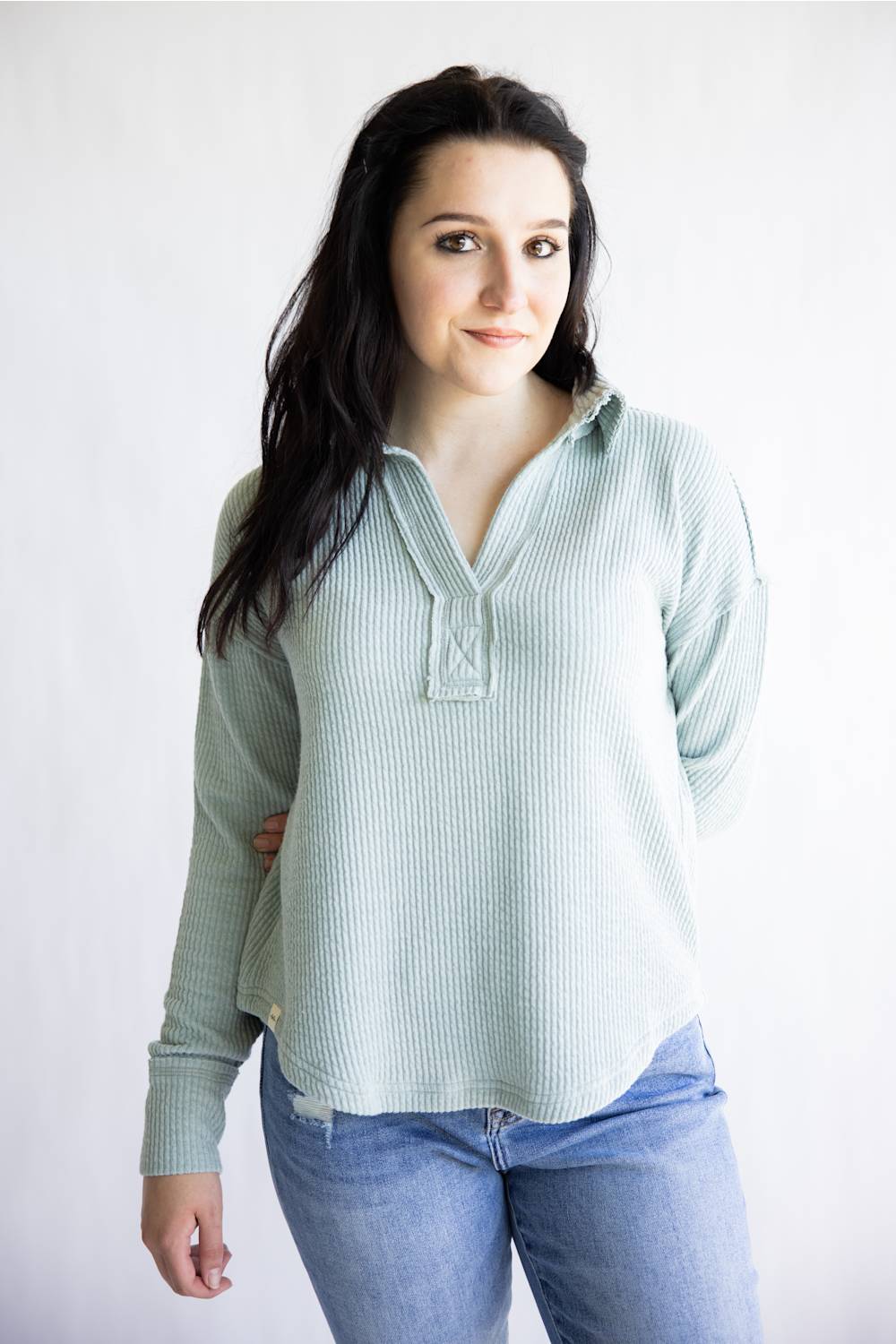 Ribbed v-neck sweater with long sleeves and exposed seams in light teal