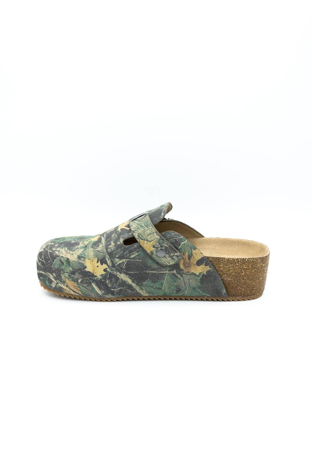 A single clog-style mule shoe in a green and brown woodland camouflage pattern, featuring a cork wedge heel and a tan insole, shown from a side profile on a white background.