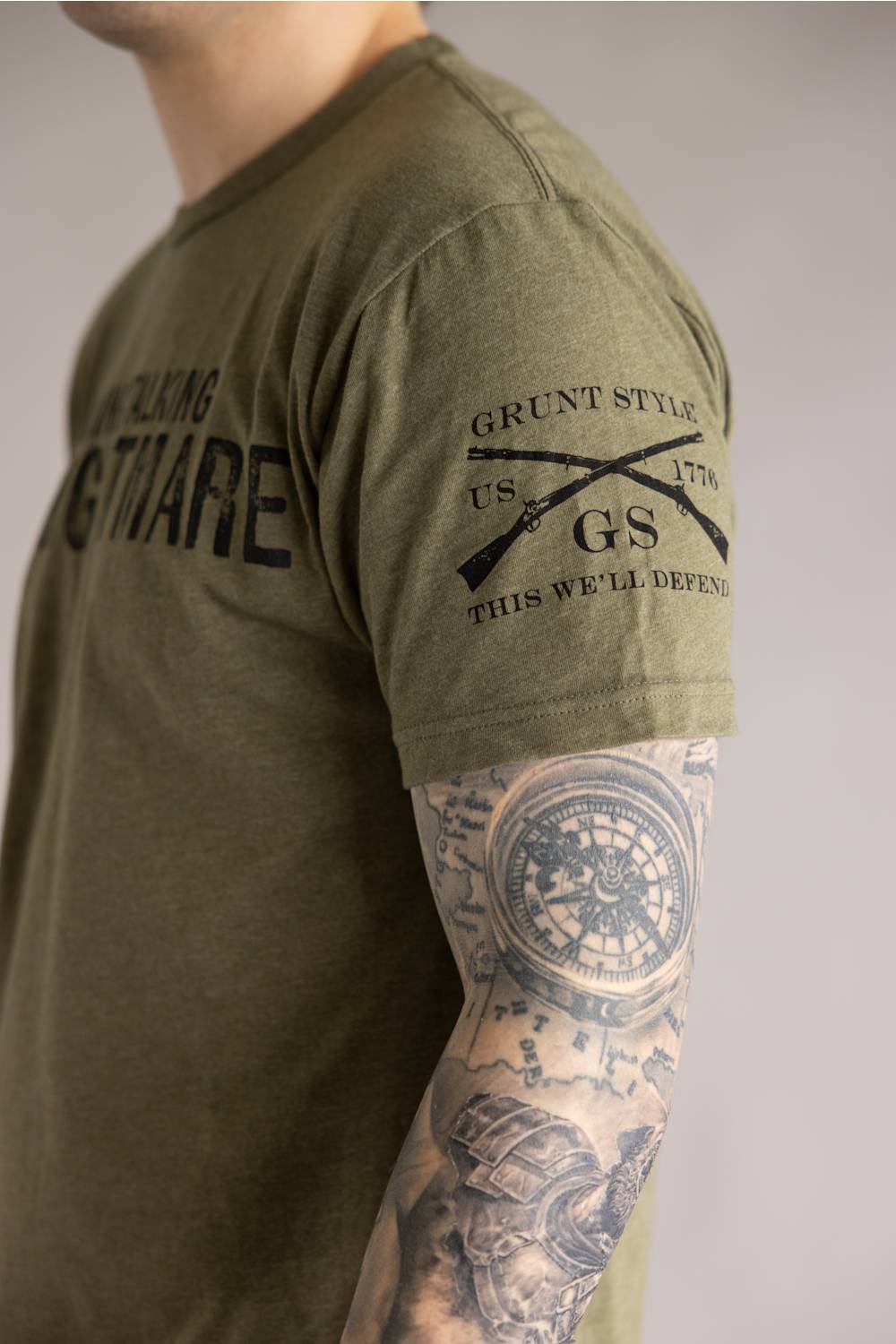 Grunt Style 1776 HR Nightmare T-Shirt for Men in Green; Person wearing a green t-shirt with military-themed text and graphics, standing against a neutral background.