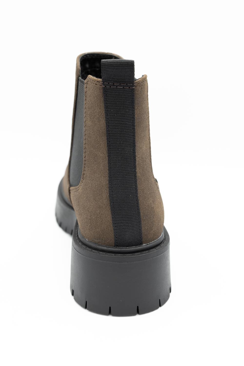 A single ankle boot shown from the back on a plain white background. The boot features a taupe-brown suede upper with a black elastic side panel and a thick black sole.