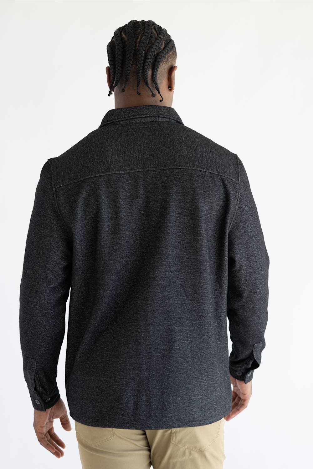 A man wearing a Hallstatt full zip Knit Jacket for Men in Charcoal Grey with two chest pockets.