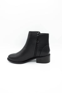 A black leather ankle boot with a low block heel shown against a plain white background.