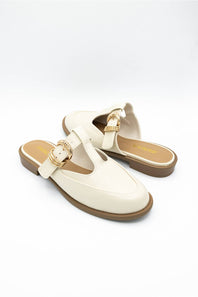 A pair of off-white leather T-strap mule sandals with gold-tone buckle details and brown soles, displayed on a clean white background.
