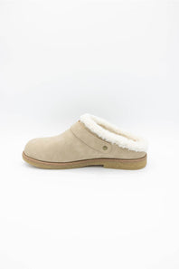 A single beige suede clog slipper with a white faux-shearling lining and a tan sole, shown in profile against a plain white background.