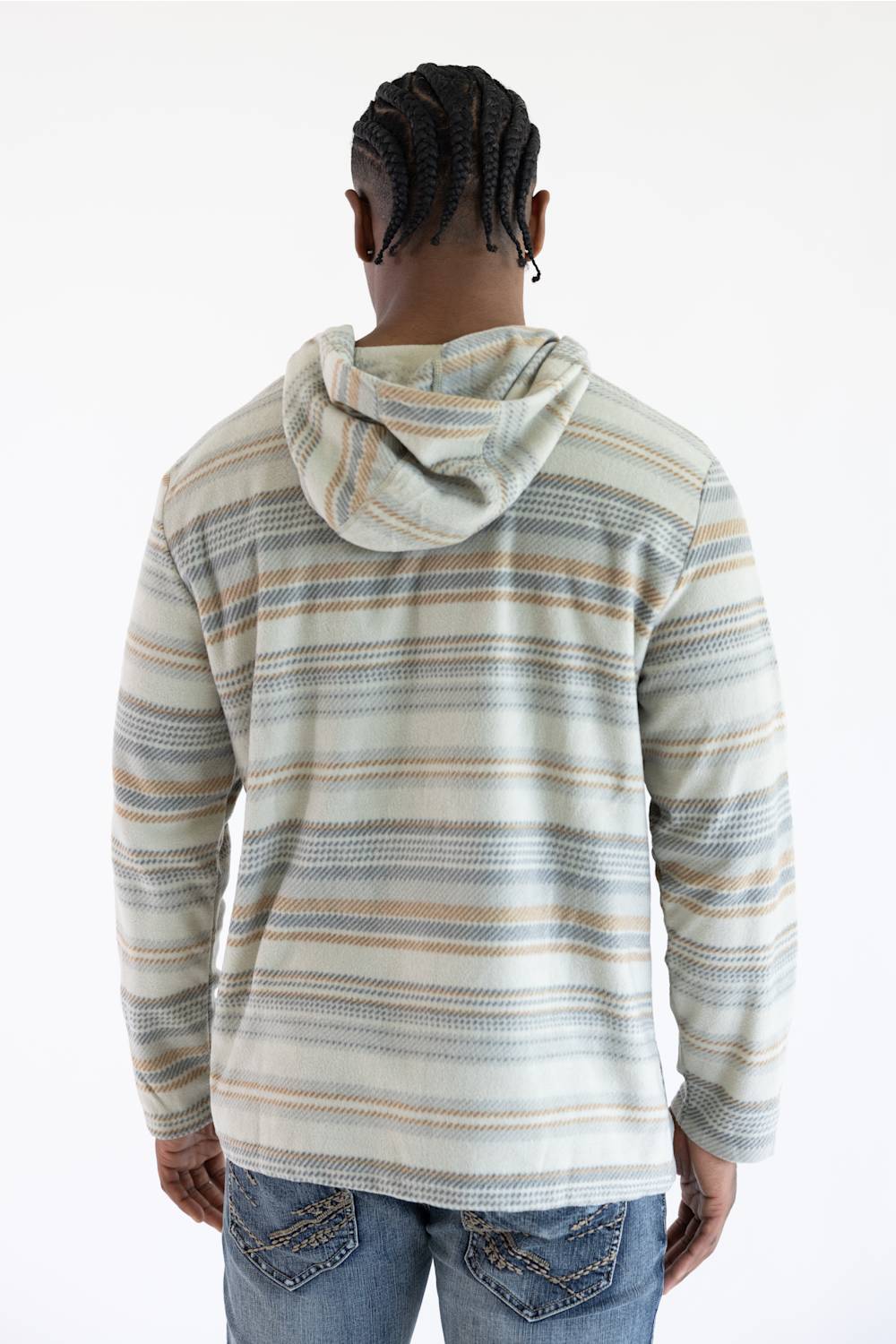 A man viewed from behind wearing a long-sleeve hooded knit top with horizontal stripes in beige, blue, and gray on an off-white base, paired with blue jeans against a plain white background.