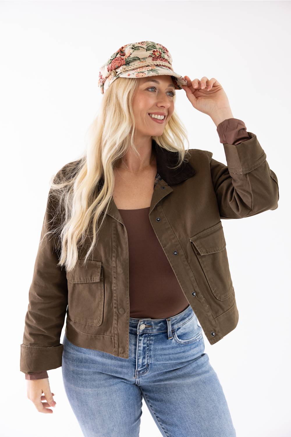 blonde woman modeling a floral jacquard newsboy cap 