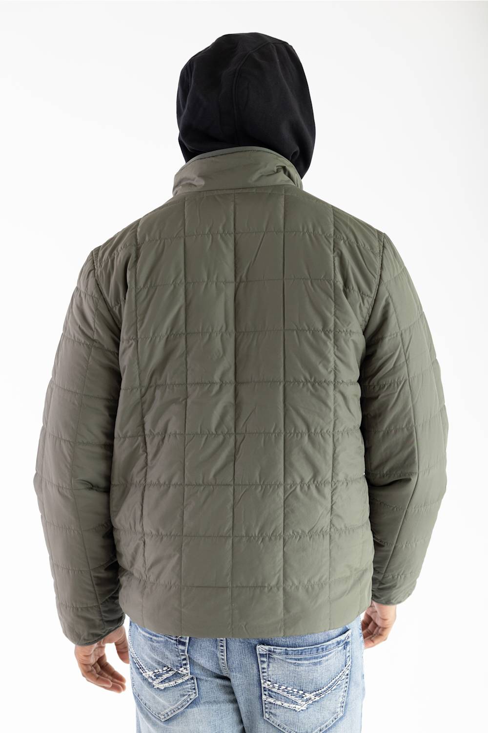 A person shown from the back wearing an olive green quilted puffer jacket over a black hoodie and blue jeans, against a plain white background.