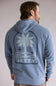Back view of a person wearing a blue hoodie with a palm tree design and 'Jetty' text on the back. The hoodie is Jetty Orbit Grove Hoodie for Men in Pigment Slate