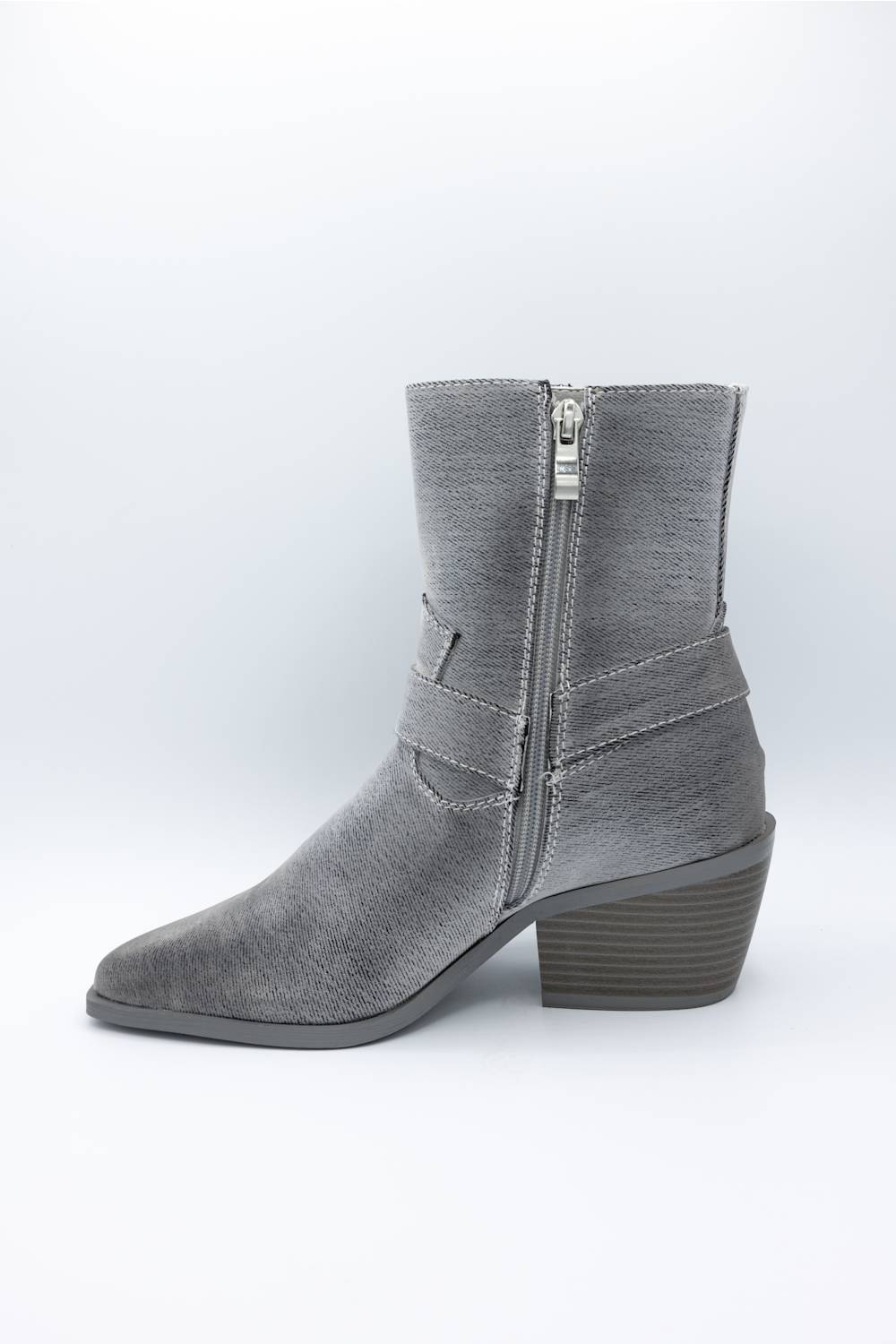 A gray suede ankle boot with a side zipper, pointed toe, and stacked block heel, shown from a side profile on a light gray background.