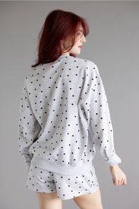 Polka Dot Fleece Crewneck for Women in Grey/Black; Person wearing a polka dot outfit on a gray background