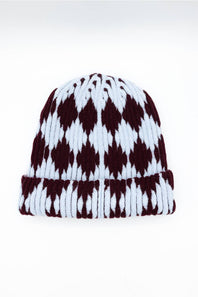 A ribbed knit beanie hat featuring a classic argyle pattern in dark burgundy and white, shown against a plain white background.