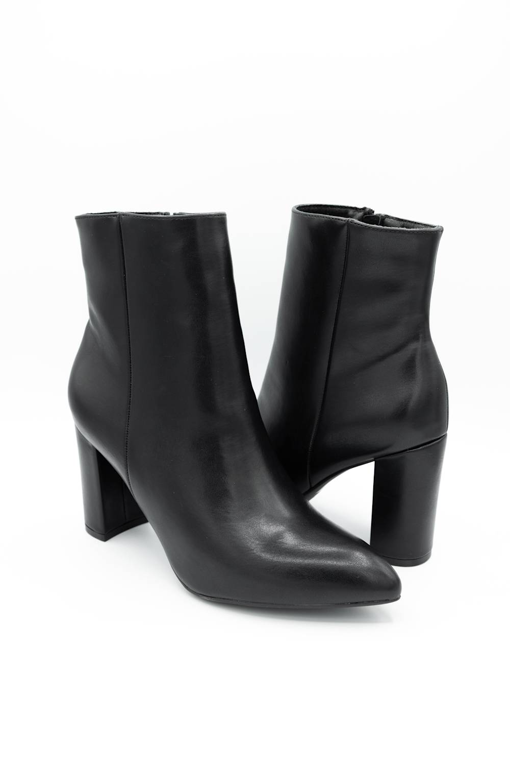 A pair of black leather ankle boots with block heels and pointed toes, shown on a clean white background.