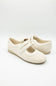 Pair of white shoes with velcro straps on a light gray background