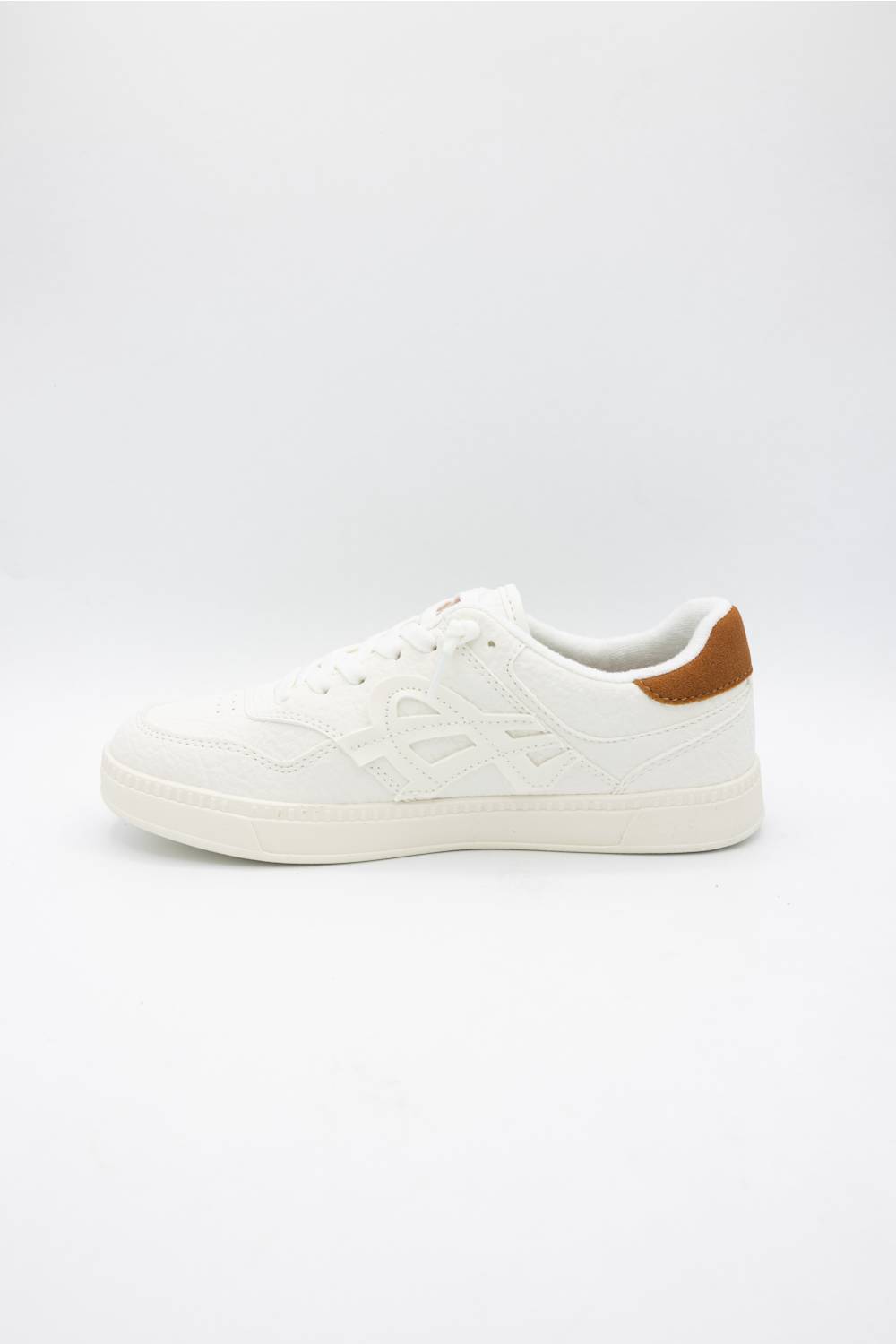 A low-top white sneaker with tonal embossed side detailing and a contrasting brown heel tab, shown from a side profile on a light gray background.