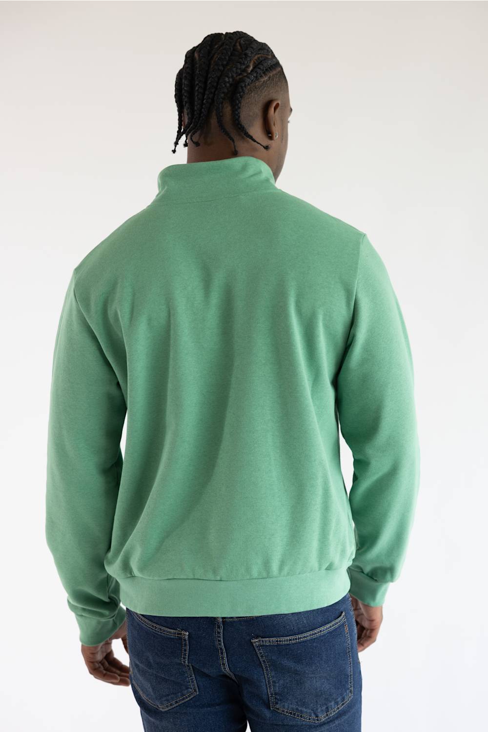 A photo from the back of a man wearing the The North Face Evolution Simple Dome ¼ Zip Neck for Men in Dimmed Algae Green with a white The North Face Logo on the upper left chest.