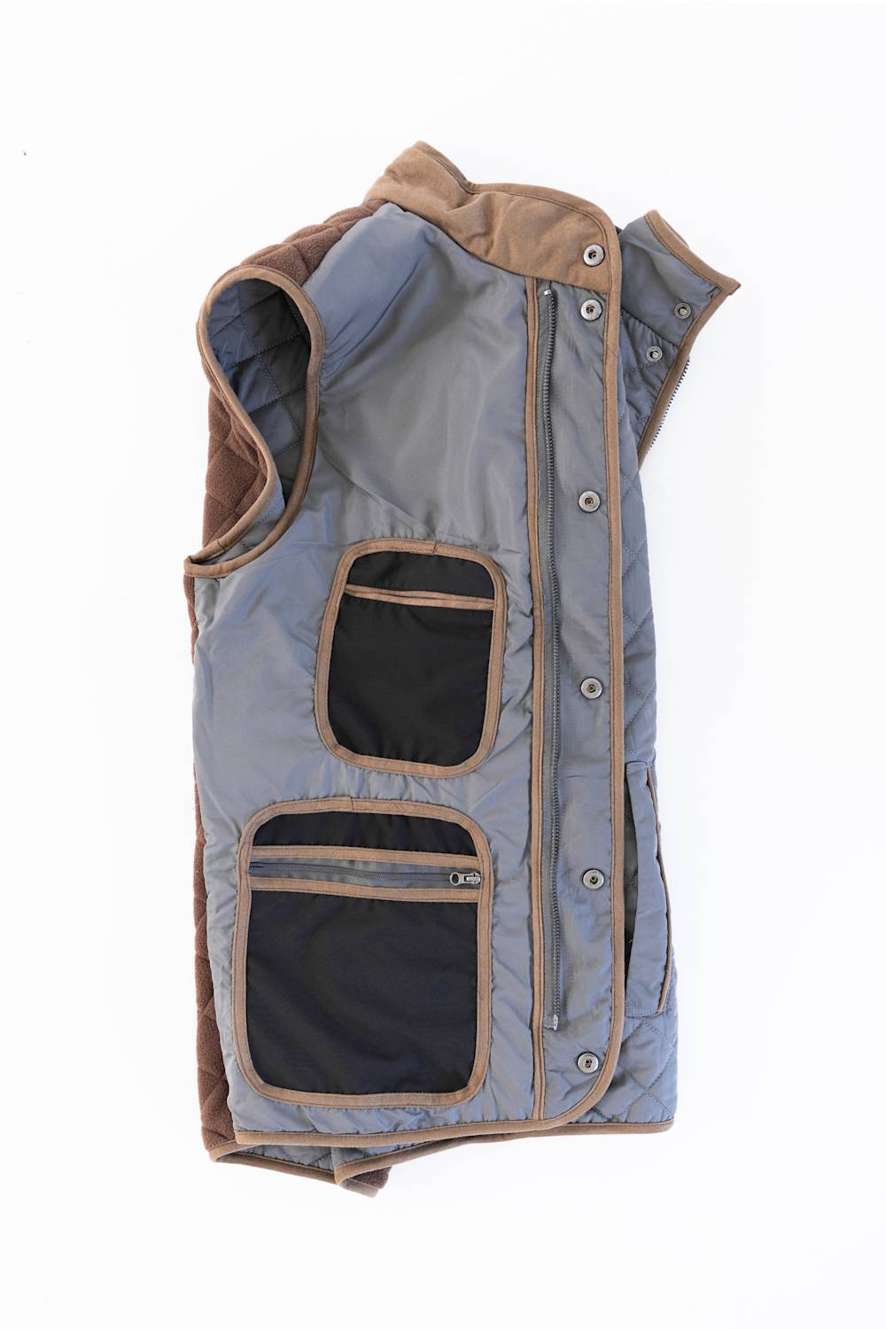 FX Fusion Upland Quilted Field Vest in charcoal shown laid flat on a white background, featuring diamond quilting, brown faux-suede contrast trim, a snap-front closure, and utility chest and hand pockets.