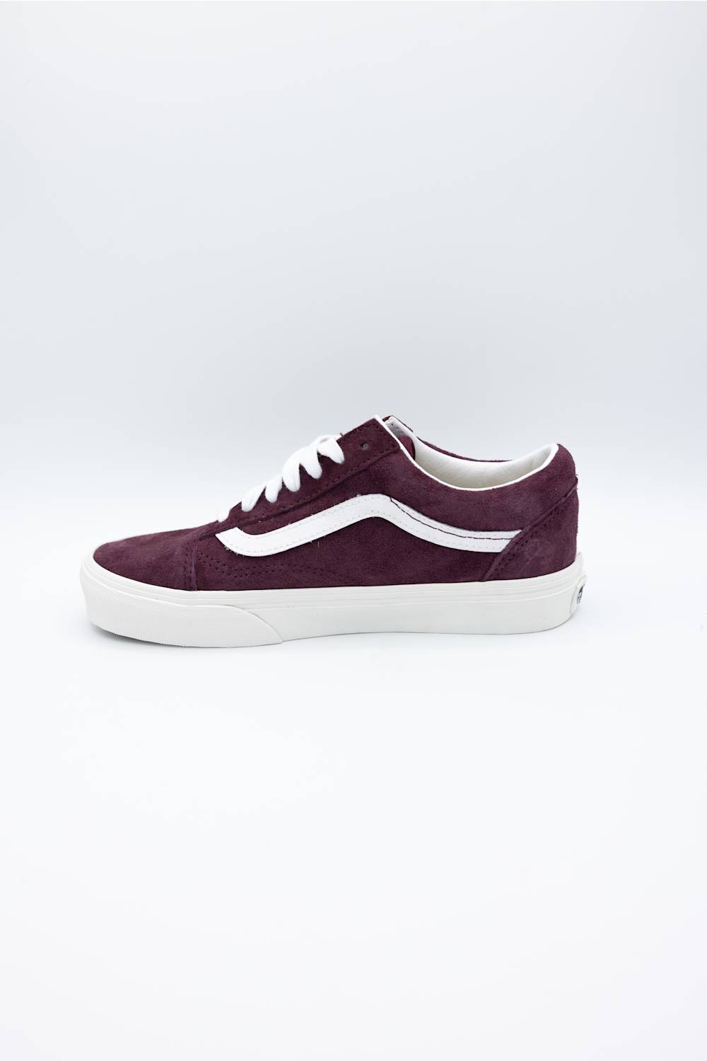 A single Vans platform sneaker in burgundy suede with a white side stripe and white laces, shown from a side profile on a light gray background.