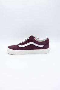 A single Vans platform sneaker in burgundy suede with a white side stripe and white laces, shown from a side profile on a light gray background.