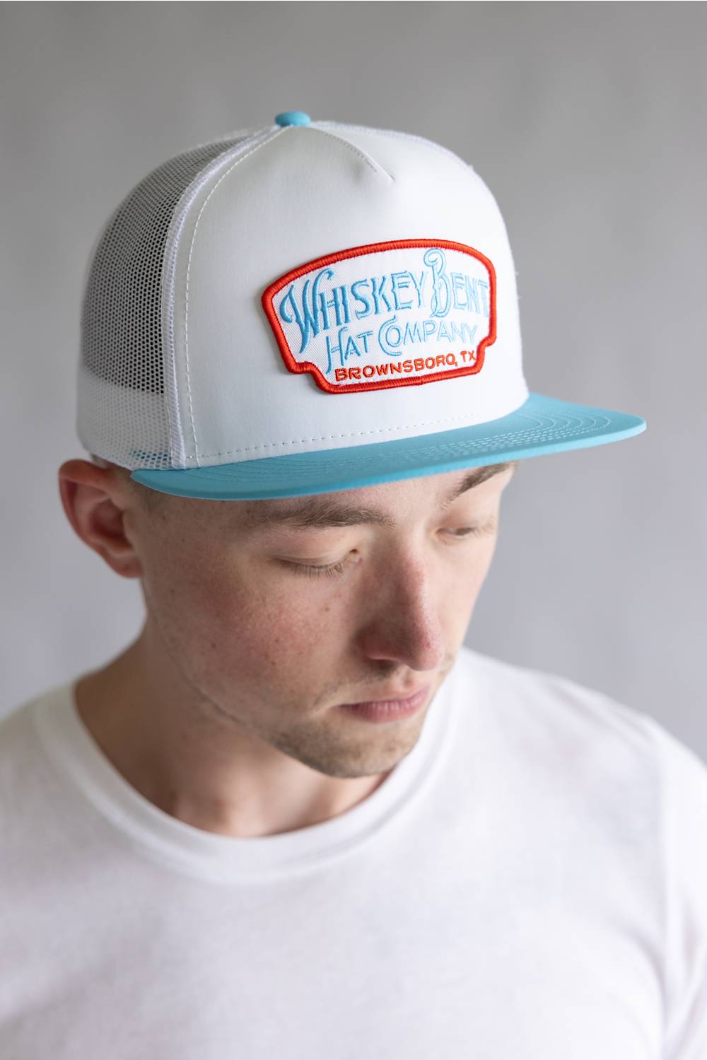 Whiskey Bent Candy Land Trucker Hat for Men in White/Teal