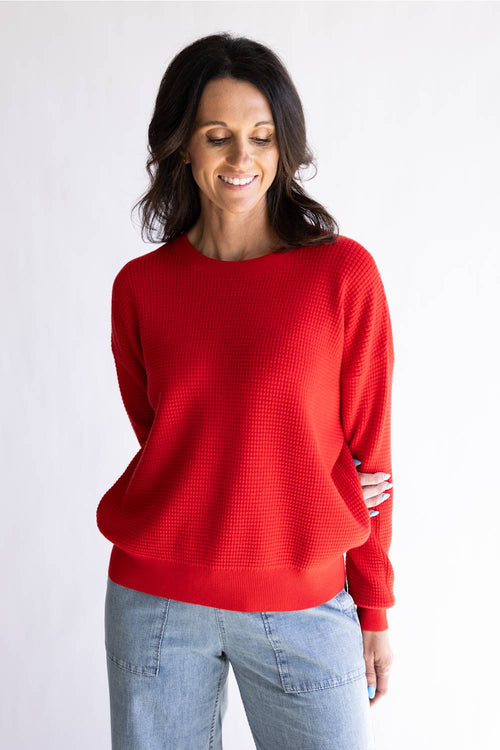 Waffle textured sweater top in a vibrant red color, with thick hems and cuffs 