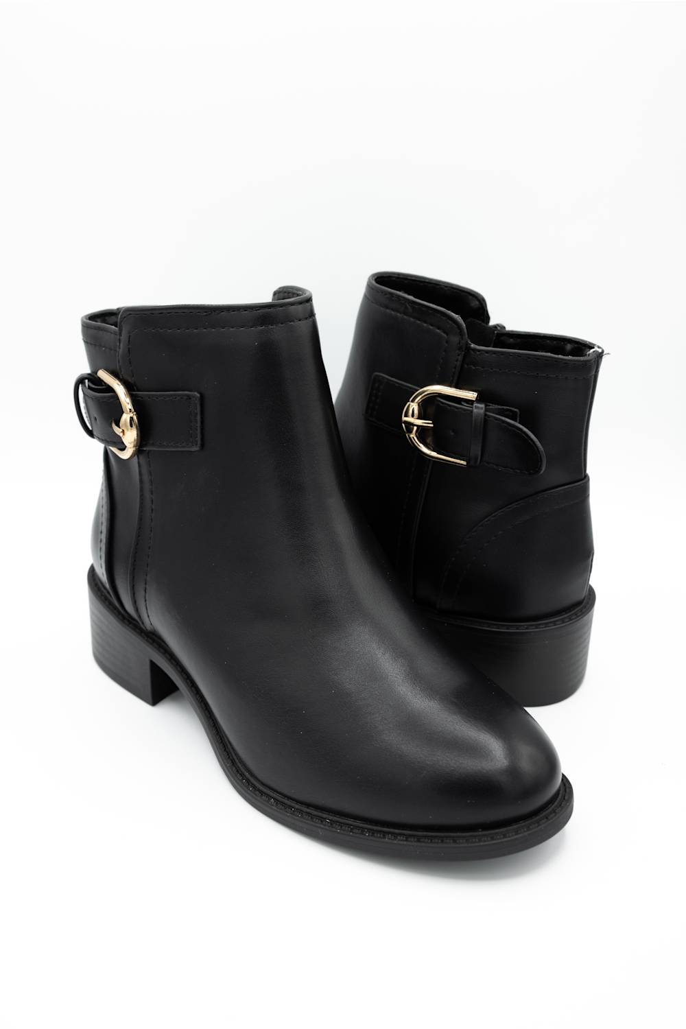 A pair of black leather ankle boots with a low block heel and a gold-tone buckle detail on the side, displayed against a clean white background.