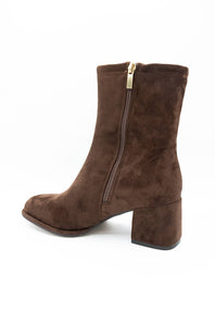 A brown suede ankle boot with a block heel and a gold-tone zipper pull, shown from a side-rear angle on a white background.