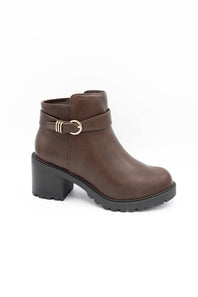 A brown faux-leather ankle boot with a chunky black block heel, a black treaded sole, and a decorative strap with a gold buckle on the side, shown against a plain white background.