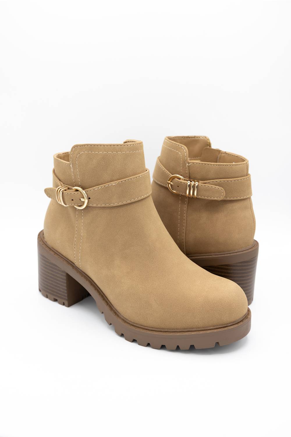 A pair of tan suede ankle boots with a side buckle strap and a chunky lug sole, shown on a white background.