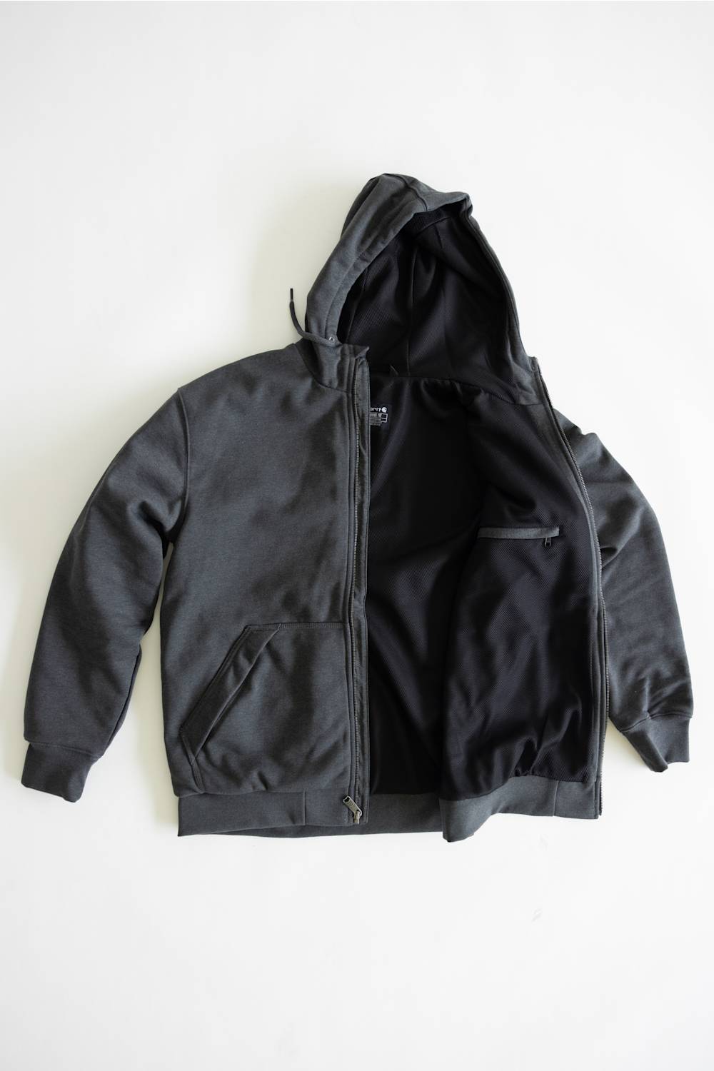 A black zip-up hoodie jacket with a matching black interior lining, laid flat against a plain white background.