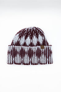 A knit cuffed beanie hat featuring a maroon and white geometric pattern, displayed against a plain white background.