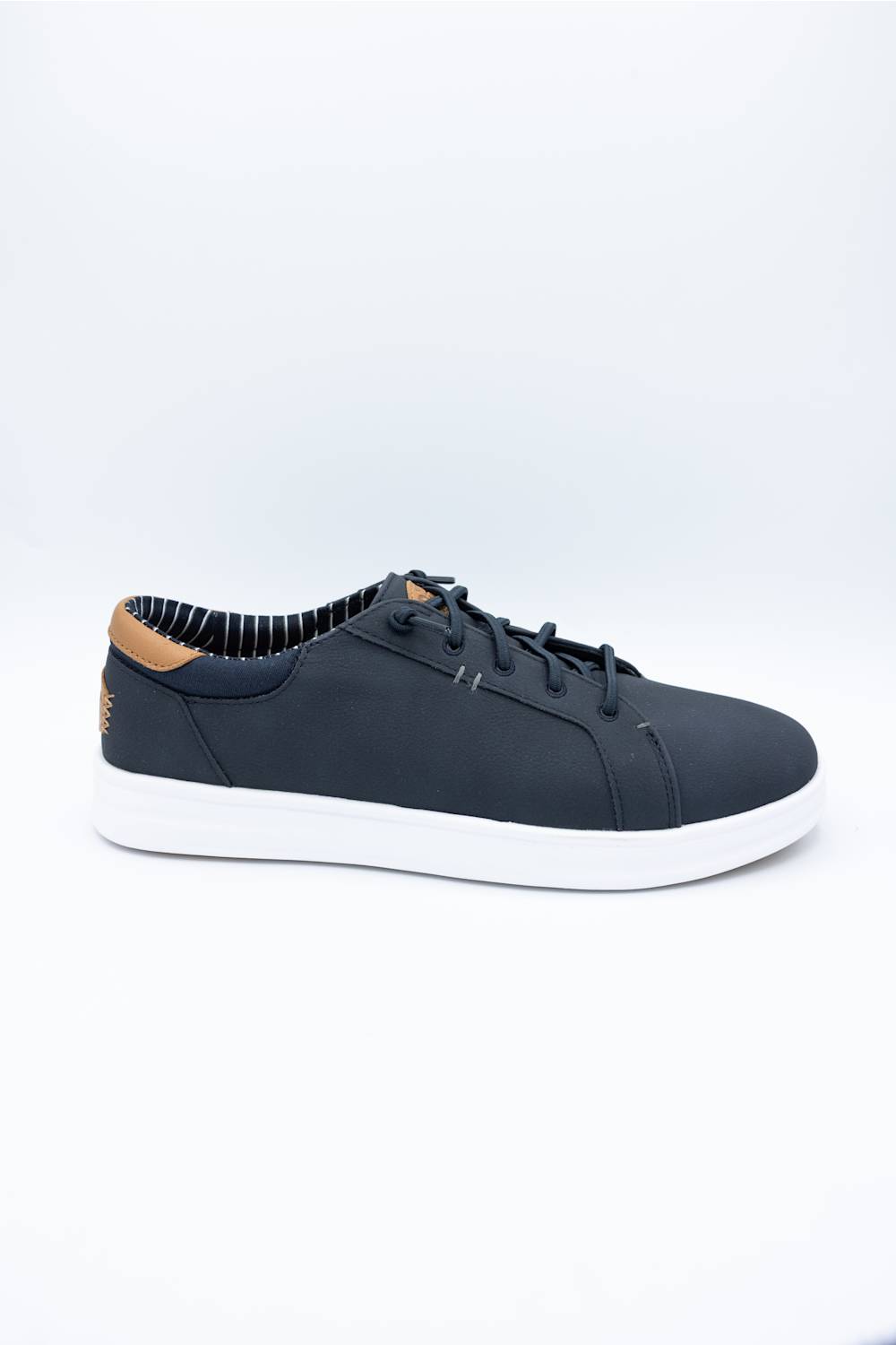 A low-top casual sneaker in dark navy blue with white soles and a light brown leather heel tab, displayed on a clean white studio background.