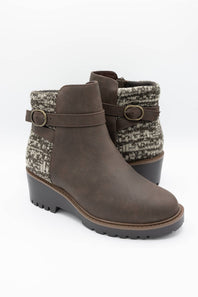 A pair of women's ankle boots in dark brown faux leather, featuring a textured gray and white knit fabric collar with a buckle strap detail, set against a plain white background.