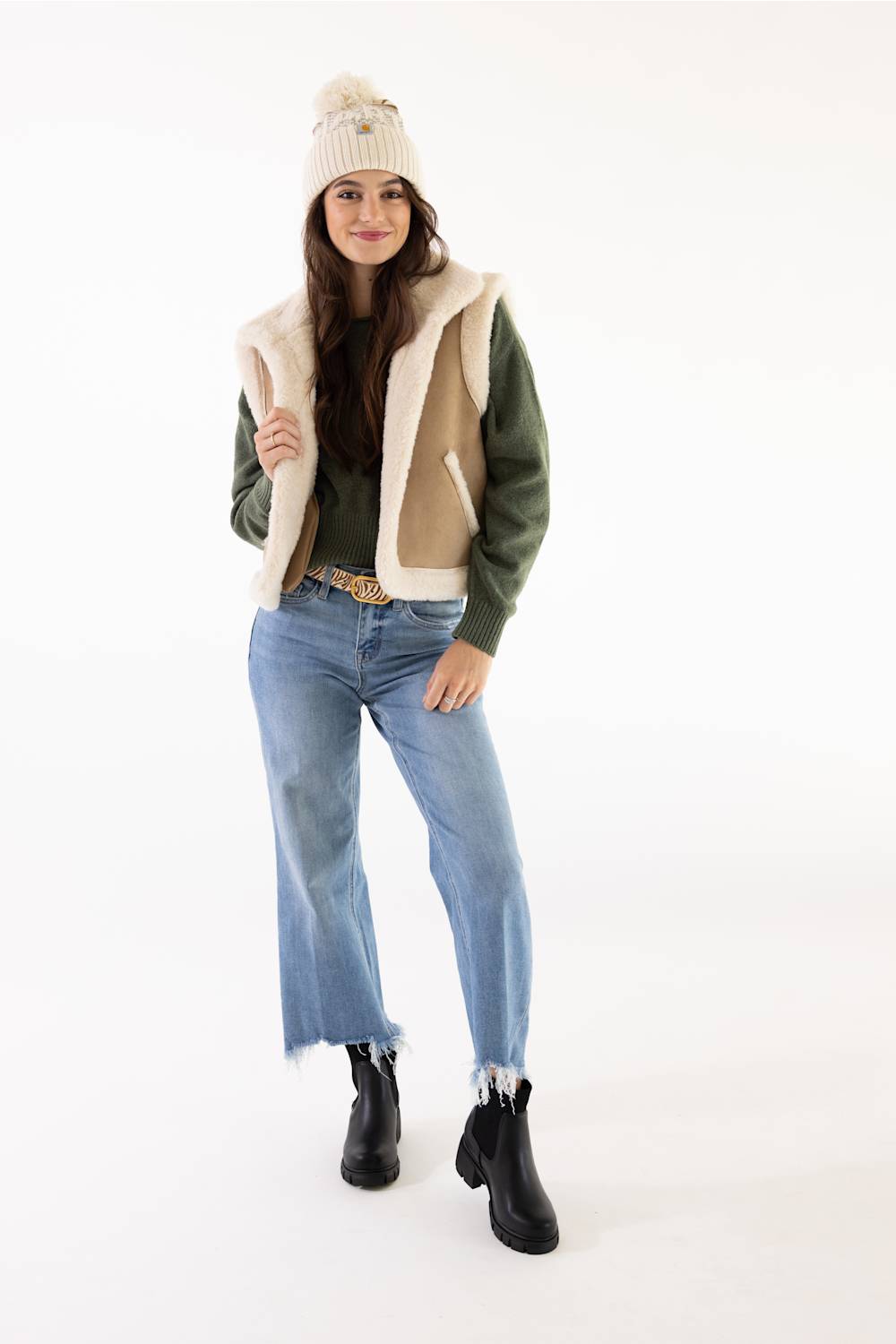 Model wearing a Carhartt thick knit cuffed beanie with a pom-pom in Oat Milk